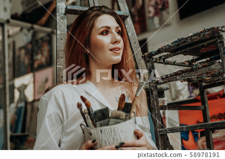 Female artist hand holding paintbrush Female artist hand holding paintbrush 58978191