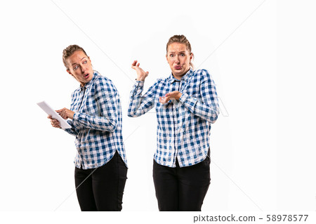 Young handsome woman arguing with herself on white studio background. 58978577