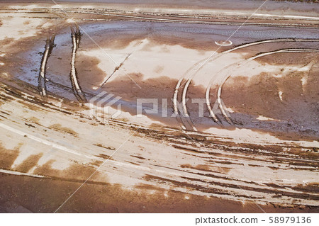 Remains on the semi-dry pavement surface of Imada Recreation Area after the water is drawn 58979136