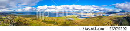 Aerial view of the coastline seen from Clooney towards Portnoo and Lettermacaward County Donegal 58979302