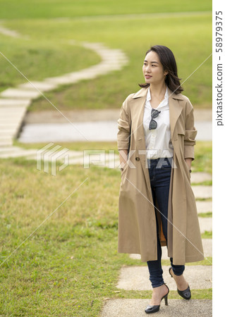 Cool woman in trench coat Cool woman in trench coat 58979375