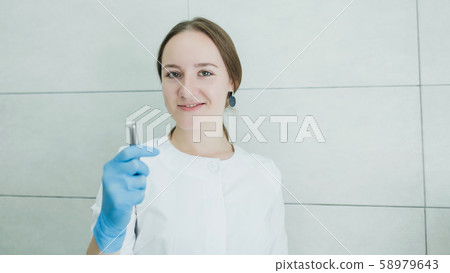 dentist with a medical instrument dentist with a medical instrument 58979643