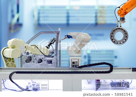 Industrial robotics teamwork working with auto parts parts in smart factory Industrial robotics teamwork working with auto parts parts in smart factory 58981541