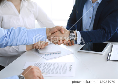 Business people shaking hands at meeting or negotiation, close-up. Group of unknown businessmen and Business people shaking hands at meeting or negotiation, close-up. Group of unknown businessmen and 58981970