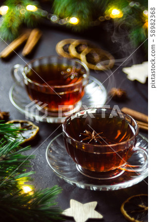 Couple cups of hot spicy tea with anise and cinnamon, selective focus. 58982368