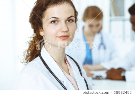 Happy doctor woman with medical staff at the hospital. Multi ethnic people group 58982493