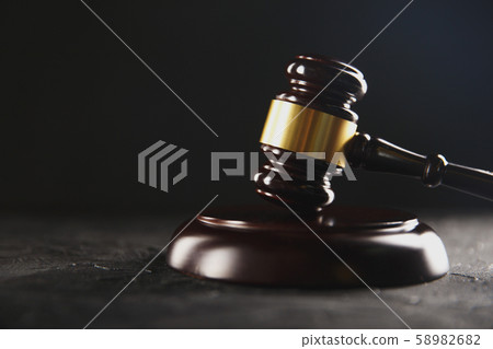 Law and justice concept. Dark gavel on the wooden table. Law and justice concept. Dark gavel on the wooden table. 58982682