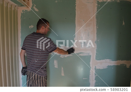 A man works in the interior of the repair and 58983201