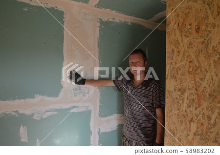 A man works in the interior of the repair and 58983202