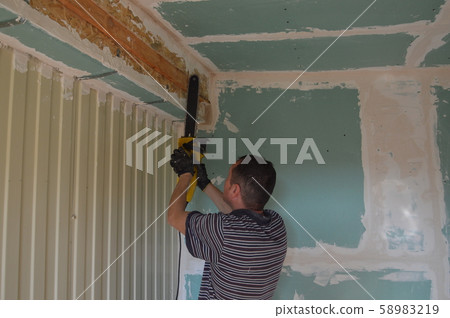 A man works in the interior of the repair and 58983219