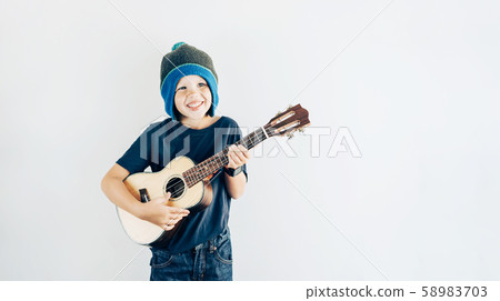 boy playing ukulele 58983703