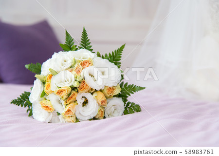 Wedding bouquet for bride on the bed 58983761