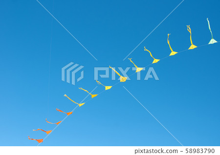 Colorful kites flying in blue sky 58983790