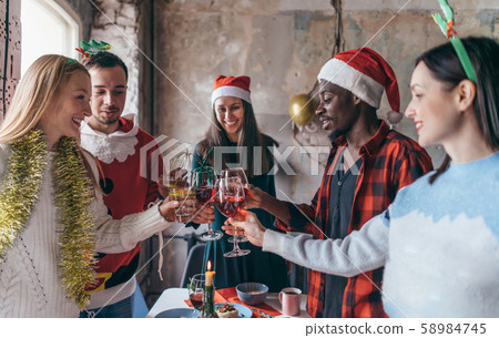 Friends celebrating Christmas or New Year eve. Friends celebrating Christmas or New Year eve. 58984745