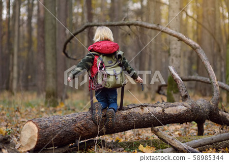 Little boy scout with backpack and rope during hiking Little boy scout with backpack and rope during hiking 58985344