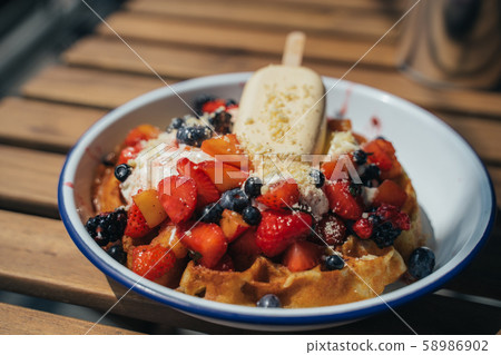 Delicious waffles with berry and ice cream Delicious waffles with berry and ice cream 58986902