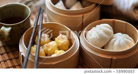Chinese steamed dumpling and steamed pork bun in a Chinese steamed dumpling and steamed pork bun in a 58990883
