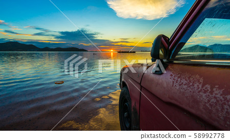 Old pickup truck parked on the waterfront with Old pickup truck parked on the waterfront with 58992778