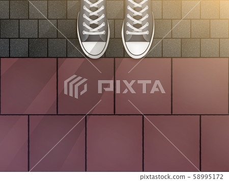 Feet in sneakers on cobblestone pavers Feet in sneakers on cobblestone pavers 58995172