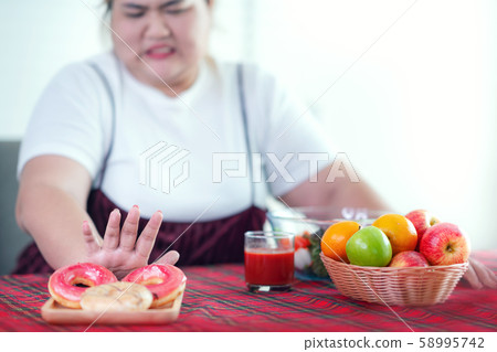 Asian fat girl stop to eat a fat food and junk Asian fat girl stop to eat a fat food and junk 58995742