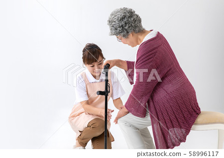 Elderly women with knee pain and helpers / caregivers Elderly women with knee pain and helpers / caregivers 58996117
