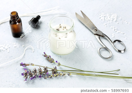 Handmade lavender scented candle with essential oil, flowers, wax and wicks. An artisanal Christmas Handmade lavender scented candle with essential oil, flowers, wax and wicks. An artisanal Christmas 58997693