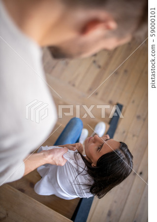 Husband touching his wife while having disagreement 59000101