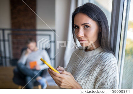 Dark-eyed wife feeling suspicious while feeling jealous 59000574