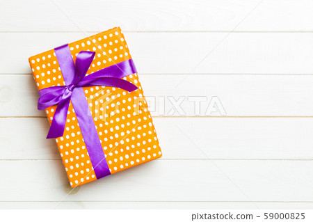 Beautiful gift box with a colored bow on the white 59000825