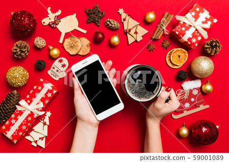 Top view of a woman holding a phone in one hand Top view of a woman holding a phone in one hand 59001089
