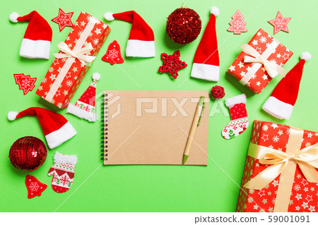 Top view of notebook on green background made of Top view of notebook on green background made of 59001091