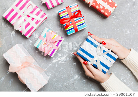 Top view of a woman holding a gift box in her Top view of a woman holding a gift box in her 59001107
