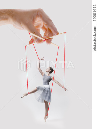 Woman like a puppet in somebodies hands. Concept of manipulation Woman like a puppet in somebodies hands. Concept of manipulation 59001611