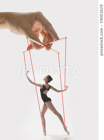 Woman like a puppet in somebodies hands. Concept of manipulation Woman like a puppet in somebodies hands. Concept of manipulation 59001629
