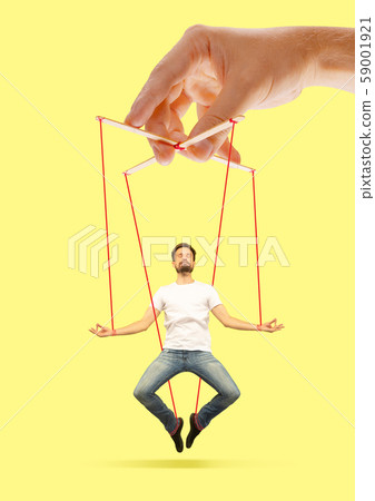Man like a puppet in somebodies hands. Concept of manipulation Man like a puppet in somebodies hands. Concept of manipulation 59001921