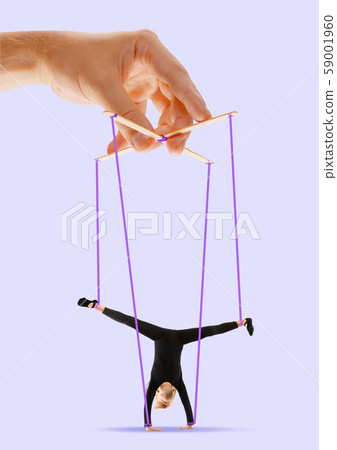 Girl like a puppet in somebodies hands. Concept of manipulation Girl like a puppet in somebodies hands. Concept of manipulation 59001960