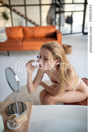 Top view of woman doing makeup in the living room 59002641