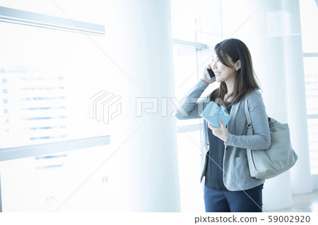 A woman talking on a smartphone A woman talking on a smartphone 59002920
