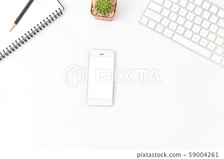 Top view of working desk with smartphone, computer and office supplies Top view of working desk with smartphone, computer and office supplies 59004261
