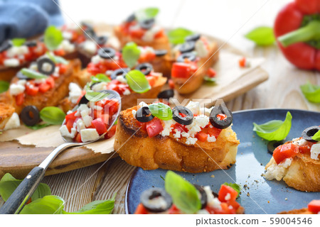 Warm Greek bruschetta with feta cheese Warm Greek bruschetta with feta cheese 59004546