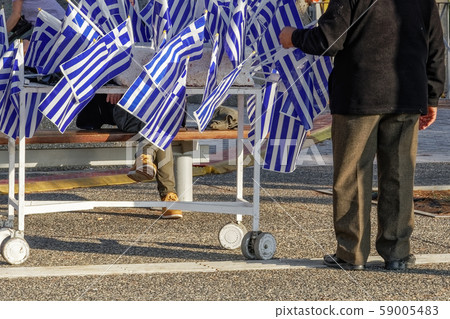 Street vendor selling Greek flags. Street vendor selling Greek flags. 59005483