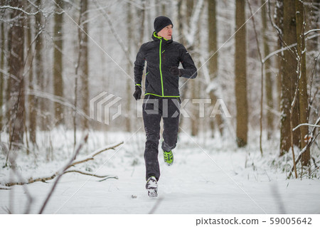 Photo of man in sportswear, black hat jogging in winter Photo of man in sportswear, black hat jogging in winter 59005642