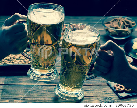 Appetizers and beer on the table for watch the football match. Appetizers and beer on the table for watch the football match. 59005750