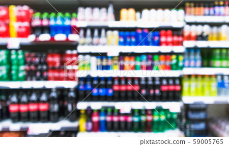 Blurred variety of soft drinks,energy drinks and sport drinks on shelves at grocery store supermarket Blurred variety of soft drinks,energy drinks and sport drinks on shelves at grocery store supermarket 59005765