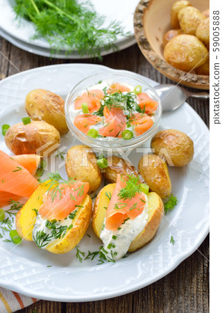 Baby jacket potatoes fresh from the oven served with herb curd and smoked salmon 59005888