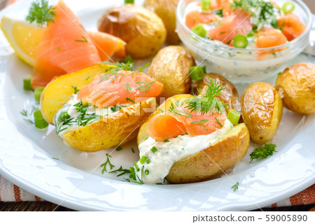 Baby jacket potatoes fresh from the oven served with herb curd and smoked salmon 59005890