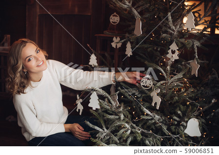 Brunette in hat with hot drink on wooden porch 59006851