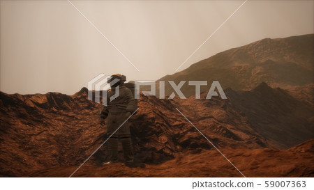 Spaceman walks on the red planet Mars. Space 59007363
