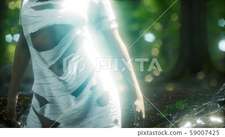 young woman in torn t-shirt in green forest 59007425