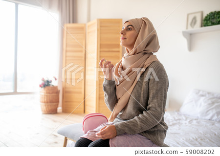 Pretty young girl enjoying the smell of her new perfume Pretty young girl enjoying the smell of her new perfume 59008202